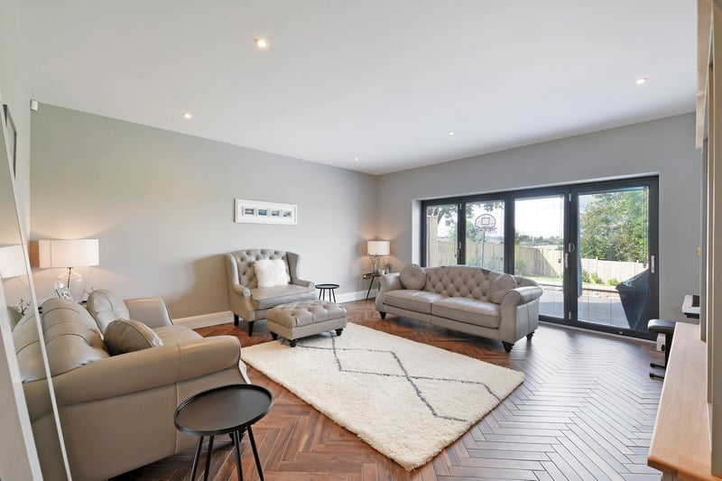 A generously sized reception room with tiled flooring and under floor heating also featuring Bi-fold aluminium doors that open up onto the garden.
