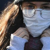 A woman wears a protective face mask as fears over coronavirus grow.. (Photo: Getty Images)