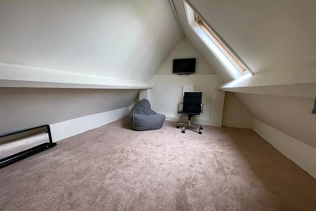 This room is one of two in the attic that could accommodate a bedroom or home office.
