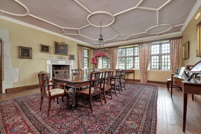 The formal dining room has a fine moulded ceiling and a  fireplace with marble surround.