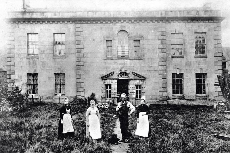 The south front of Coney Green Hall, in North Wingfield taken in 1883 with the Clay Cross bailiff, wife and two servants standing in front. Note the unkempt garden. Francis Brailsford, a member of an ancient knightly family long settled in North Wingfield, built a new house in around 1762. The architect was probably Edmund Stanley of Chesterfield, who clearly liked to bend the rules of Palladian architecture. In 1873, George Banks Wilson sold it and the small park to the ClayCross Company, who installed their bailiff and tipped iron slag onto the parkland.Undermined by subsidence, it was demolished in advance of further coal mining in 1890.