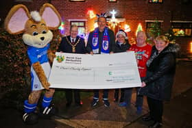 Chesterfield FC mascot Chester the Fieldmouse, Councillor Martin Thacker, Paul Goodwin, Kimberley Pollard and Steve and Janet Pollard with the £1,000 cheque for Ashgate Hospice. Pictures by Brian Eyre.