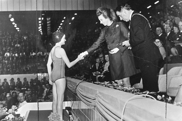 Princess Anne presents a medal to Joyce Quinn, 12,  of Musselburgh, one of the first swimmers to dive into the new Royal Commonwealth Pool and who took part in its opening ceremony.