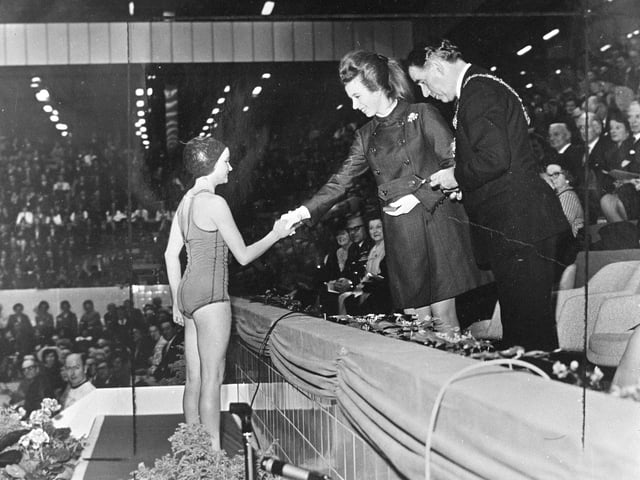 Princess Anne presents a medal to Joyce Quinn, 12,  of Musselburgh, one of the first swimmers to dive into the new Royal Commonwealth Pool and who took part in its opening ceremony.