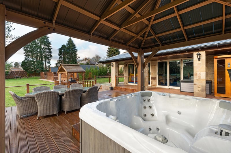 The lodge boasts a covered decking area with jacuzzi.
