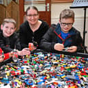 Mum Lisa with Reuben, Joel and Ethan get busy building at Brickfest