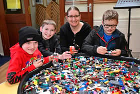 Mum Lisa with Reuben, Joel and Ethan get busy building at Brickfest