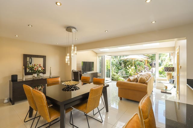 The dining area flows through to the informal lounge where doors open onto the beautiful landscaped  rear garden.