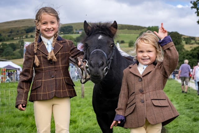 Florance Hague, 6, and her sister Chloe, 4, with May the Shetland pony.