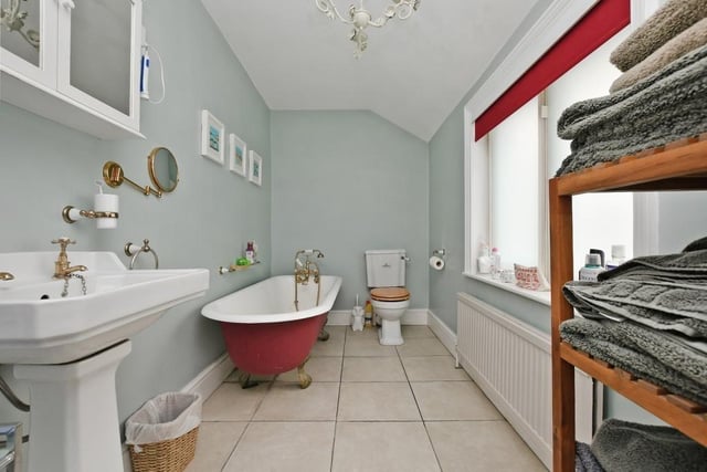 The roll top bath adds a splash of colour to the bathroom in The Red House.
