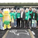 The NSPCC's Sir Peter Wanless with charity staff, volunteers and Pantosaurus.