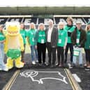 The NSPCC's Sir Peter Wanless with charity staff, volunteers and Pantosaurus.
