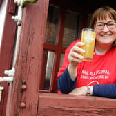 Alexa Stott, marketing manager for Barrow Hill Roundhouse, raises a glass to a successful Rail Ale festival. She is holding a beer produced by the Alphito Neepsend Brew Co, chosen by brewers as the champion beer of the festival.
