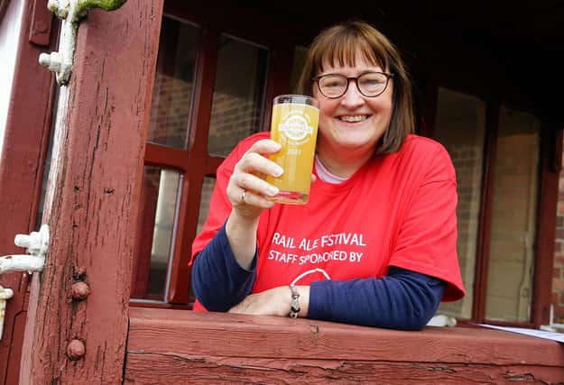 Alexa Stott, marketing manager for Barrow Hill Roundhouse, raises a glass to a successful Rail Ale festival. She is holding a beer produced by the Alphito Neepsend Brew Co, chosen by brewers as the champion beer of the festival.