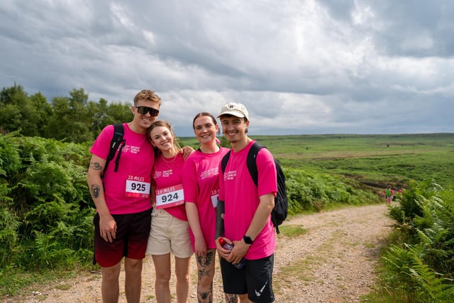 A shoulder to lean on during a brief pause in the walk to smile for the photographer. Photo: Breast Cancer Now