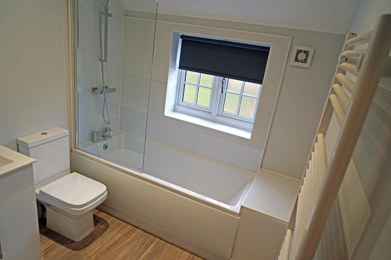 Cosy bathroom, complete with over-bath shower and towel radiator