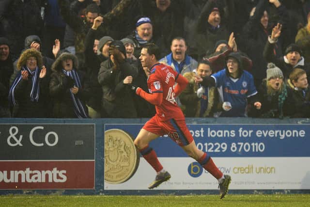Ian Henderson celebrates in front of the Rochdale fans after scoring against Barrow. (Photo by Mark Runnacles/Getty Images)