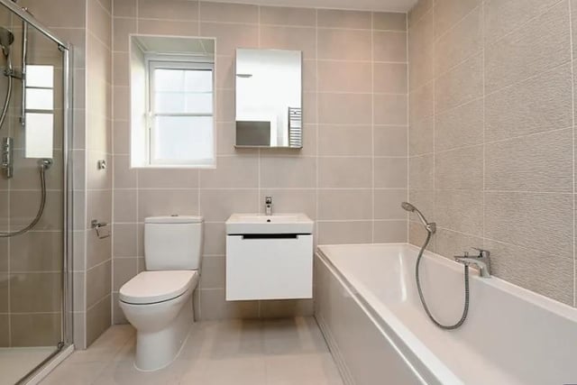 The bathroom is fully tiled and contains a bath, separate digital shower, hand basin and wc.