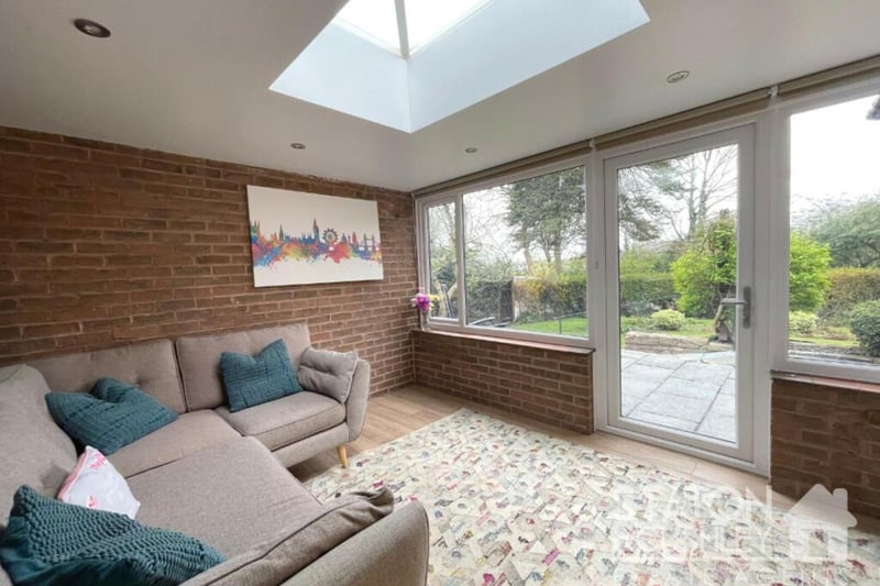 Another attractive living space at the £525,000 property is this comfortable conservatory, which overlooks the back garden. A door opens out to that garden, while further bi-fold doors lead back to the lounge.
