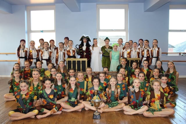 Proud students in their Whittington Moor studio with the junior troupe's trophy after impressing judges with the Peter Pan and Wendy dance.