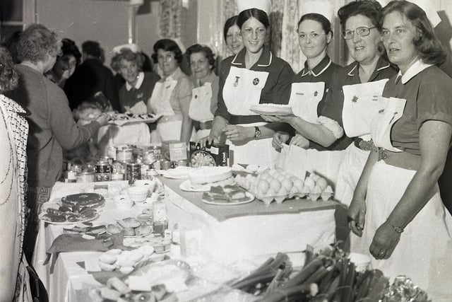Nurses selling cakes and produce at the opening of the new casualty ward at Buxton's Cottage Hospital