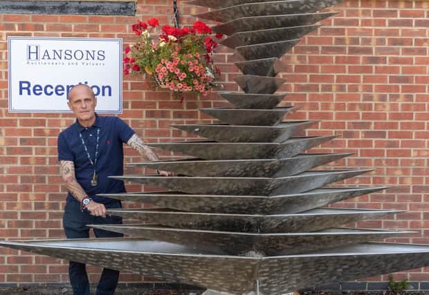Hansons valuer Karl Martin with the Malcolm Robertson sculpture outside the Etwall showroom.