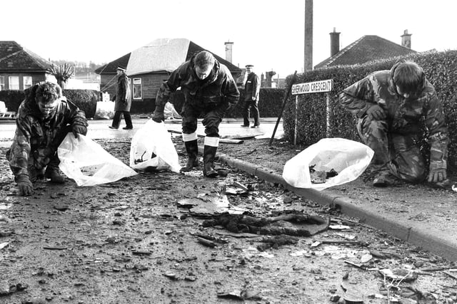 Royal Airforce crash team sift through debris left in Sherwood Crescent by the wreckage of the Pan Am flight 103 Boeing 747.