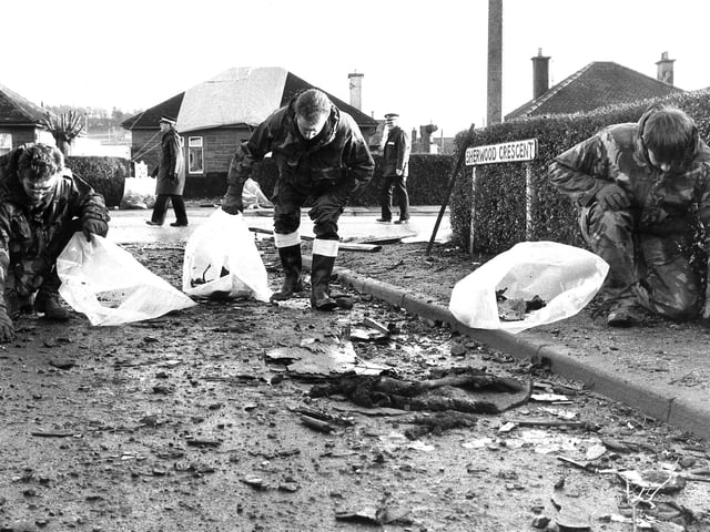 Royal Airforce crash team sift through debris left in Sherwood Crescent by the wreckage of the Pan Am flight 103 Boeing 747.