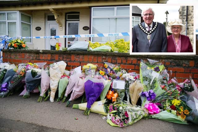 Flowers and messages of condolences have been left outside the couple's home and inset, Freda Walker and her husband Ken.