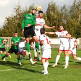 Tom Ward goes up for a header during the defeat to Lincoln. Photo: Steve W Davies Photography.