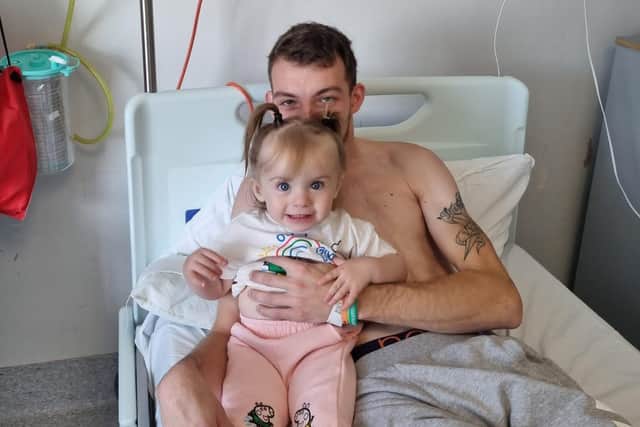 Archie in hospital with his daughter Amelia.