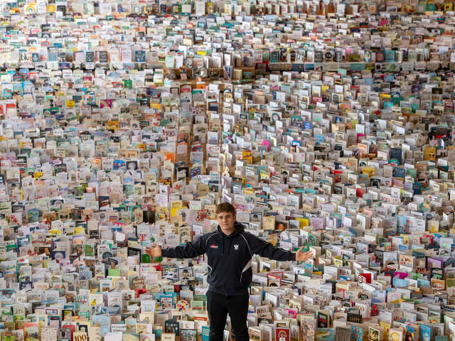 Captain Tom Moore's grandson Benjie, in the Great Hall of Bedford School, Bedfordshire, where over 120,000 birthday cards sent from around the world to celebrate Captain Tom's 100th birthday are being opened and displayed by staff.