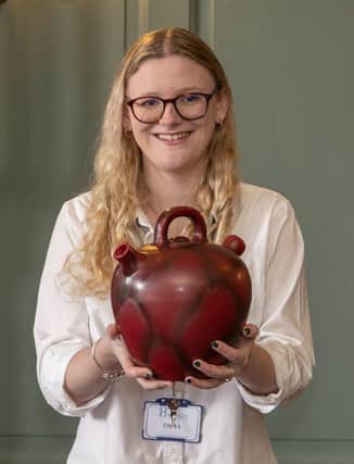 Hansons staff member Emma Errington with an example of Bretby Pottery.
