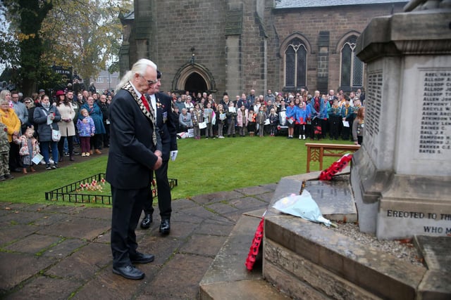 Ripley mayor Nigel Weaving bows his head after laying the town wreath.