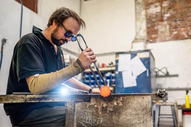 Jonathan Abbott, of Lumsdale Glass, Matlock who makes high end crystal glass baubles from his studio in preparation for Christmas.
