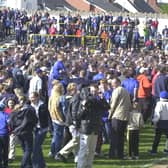 Fans invade the pitch on the last game of the season after winning promotion from Division Three.