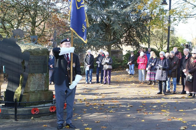 Members of the public paying their respects at the war memorial in Hall Leys Park.