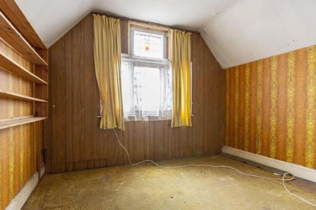 Wood panelling and colourful wallpaper bring a retro touch to this bedroom.