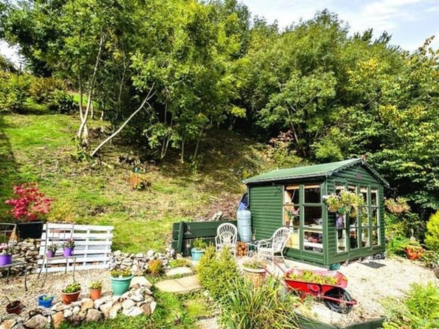 Enjoy the view from the terraced garden outdoors when the weather is fine or from the summerhouse on wet or cold days.