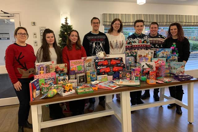 Members of Lubrizol's charities and communities committee with their toy collection