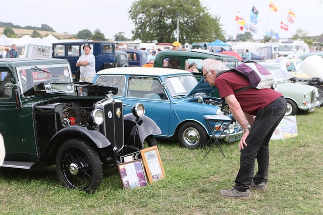 A visitor checking out the history of one of the oldest cars on show.