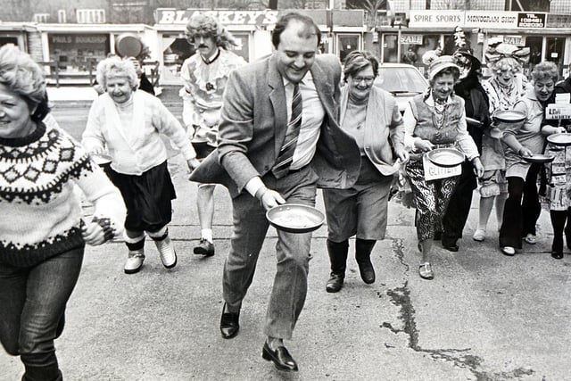 Shrove Tuesday pancake race with bank staff and customers on Beetwell Street, 1986.