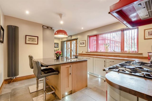 Next stop at the £550,000 house is the kitchen/breakfast room, which includes a central island with granite work surface and an inset sink with swan-neck mixer tap. A range cooker with five-ring gas hob is included in the sale.