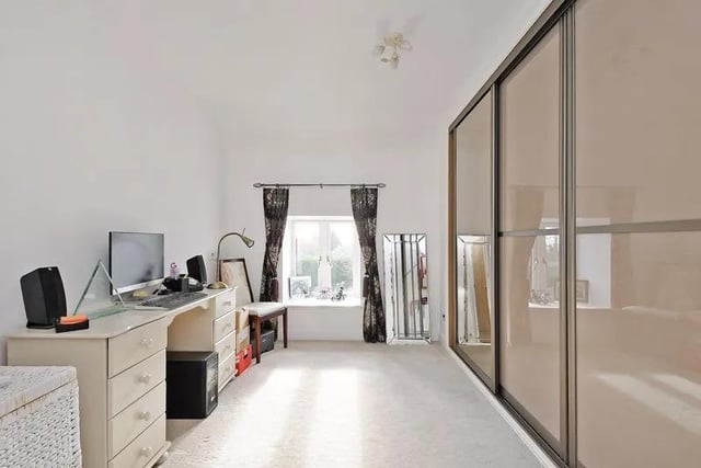 On the first floor, the first double bedroom is currently used as a dressing room and has fitted sliding door mirror wardrobes and a cream carpet.
