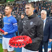 Tom Naylor and Lewis Billington lay Remembrance wreathes ahead of a minutes silence.