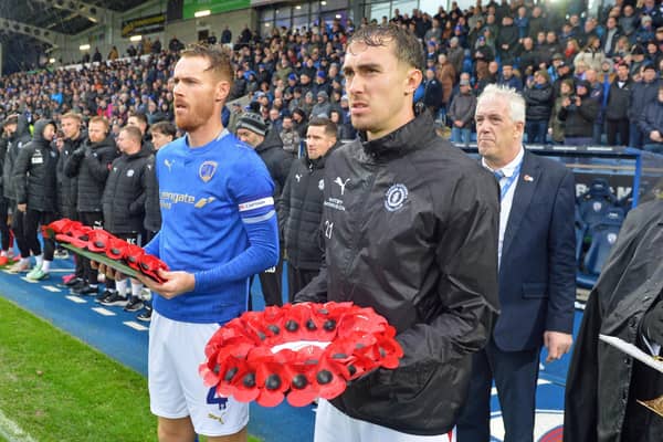 Tom Naylor and Lewis Billington lay Remembrance wreathes ahead of a minutes silence.