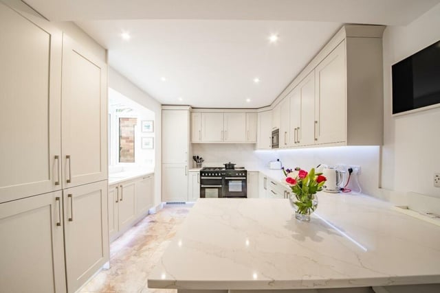 The recently fitted modern kitchen includes a breakfast bar.