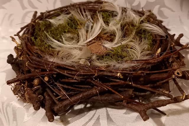 Sylvia Causer made this bird's nest from small twigs and held it together with gold thread befitting a king. The nest will be filled with tiny quails eggs to represent the 41 species of birds eaten at the banquet in Bolsover Castle in 1634.
