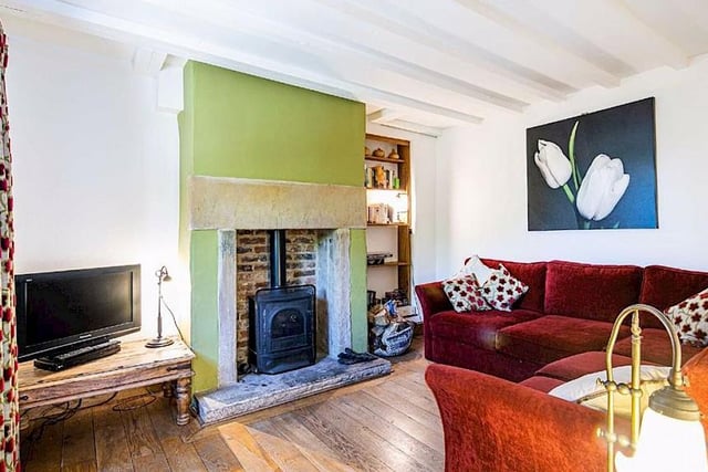 A stone fireplace and stripped-back wooden flooring make the lounge an attractive space.