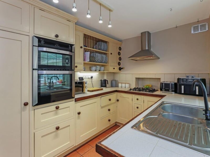 The kitchen has fitted units and integrated appliances.
